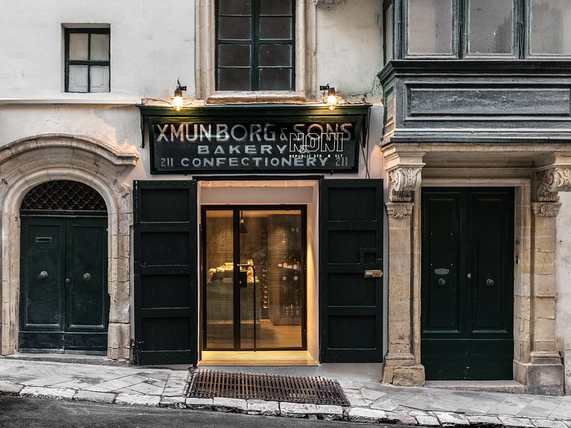 Entrance of Noni restaurant in Valletta, characterized by a chic and inviting facade with modern design elements and understated signage. The entrance exudes an aura of sophistication and intrigue, beckoning diners to embark on a culinary journey of innovation and tradition within its walls.