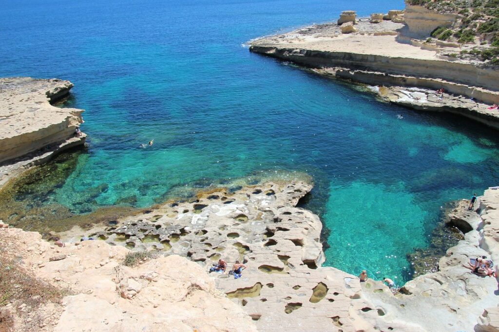 St Peter’s Pool and Il-Kalanka Bay, Malta: Natural swimming pools carved into coastal rock formations, offering serene turquoise waters against a backdrop of rugged cliffs.