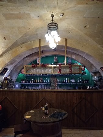 The vibrant ambiance of The Beer Cave in Valletta, with shelves adorned with an array of craft beer bottles, inviting patrons to indulge in Malta's thriving beer culture