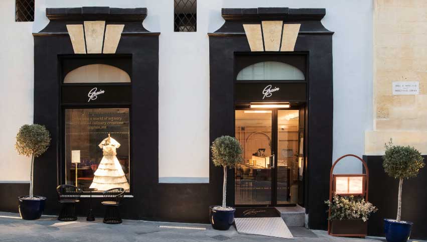 Entrance of Under Grain restaurant in Valletta, featuring a welcoming facade with a stylishly designed doorway adorned with subtle signage. The entrance exudes an air of sophistication, inviting guests to step into a world of culinary excellence and refined dining experiences.