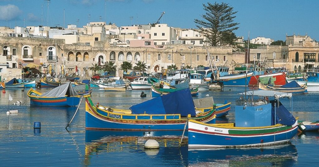 Traditional Maltese luzzu fishing boat with vibrant colors and iconic Eye of Horus, representing Malta's rich maritime heritage and fishing culture.