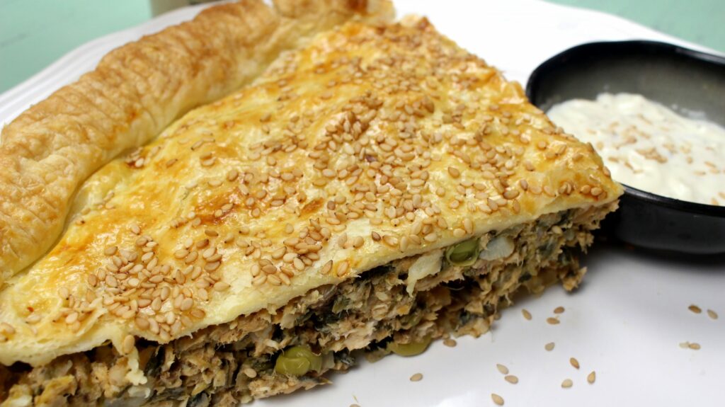 Slice of Traditional Maltese Lampuki Pie: Savoury Fish and Vegetable Pastry