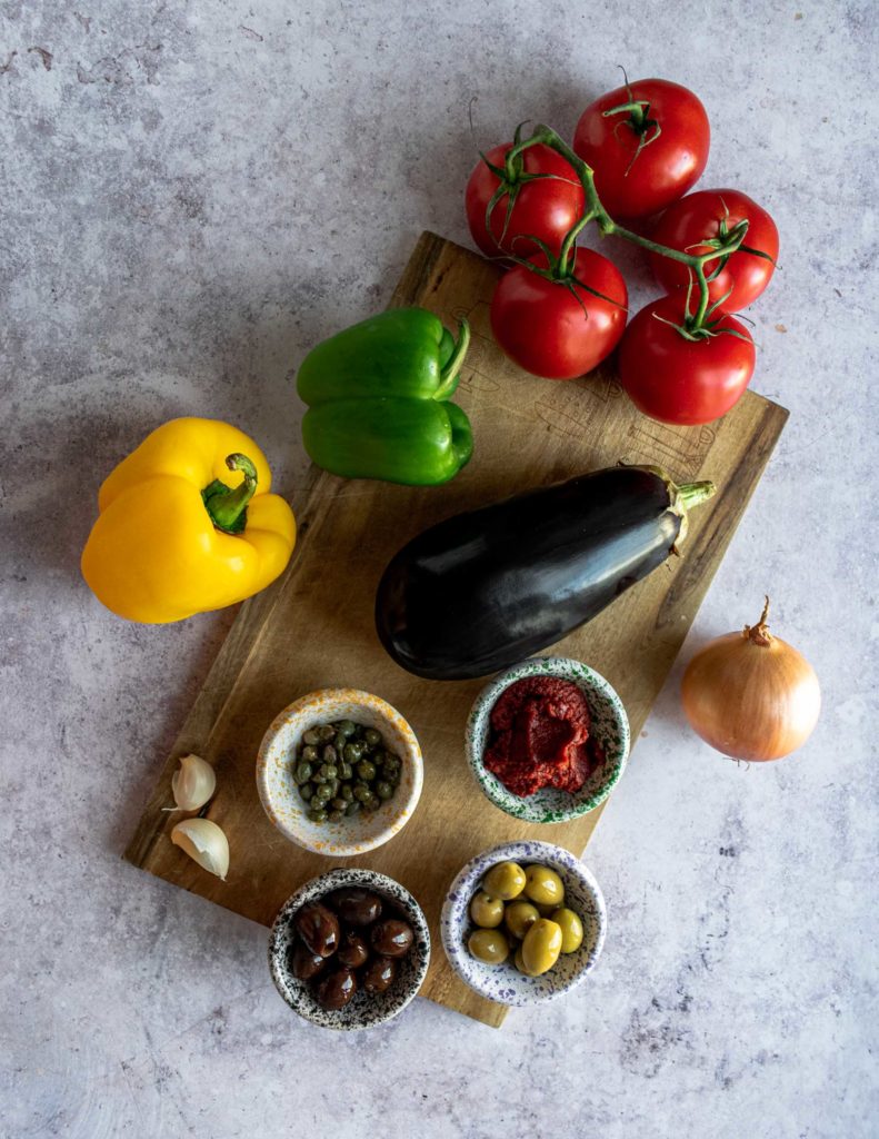 Fresh Ingredients for Maltese Kaponata: Aubergines, Tomatoes, Capers, Olives, Green Peppers