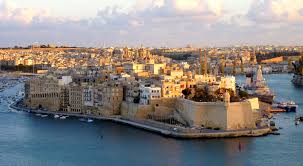 A majestic view of Fort Saint Michael in Senglea, Malta. The historic fortress stands tall against the backdrop of the azure Mediterranean Sea, its imposing walls and bastions a testament to Malta's rich military heritage. The warm glow of sunlight bathes the ancient stone structure, casting shadows and highlighting intricate architectural details. From its elevated position, the fort offers panoramic views of the surrounding cityscape and Grand Harbour, inviting visitors to explore its storied past and admire its timeless beauty.