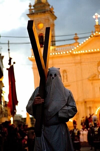 "Amidst the cobblestone streets of Qormi, Malta, a vibrant procession unfolds, showcasing the town's rich religious tradition and community spirit. Participants clad in traditional attire march solemnly, accompanied by melodious hymns and the rhythmic beat of drums. Colorful banners and ornate statues of saints adorn the procession, evoking a sense of reverence and devotion as it winds its way through the historic town center.