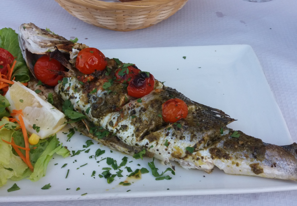 A delectable fish dish served at Tal-Barklor restaurant in Senglea, Malta. The dish features a perfectly cooked fillet of locally sourced fish, garnished with vibrant herbs and accompanied by a medley of roasted vegetables. The golden-brown skin of the fish glistens under the soft lighting, while the tender flesh flakes apart with each forkful. The dish embodies the flavors of the Mediterranean, inviting diners to enjoy a fresh and satisfying seafood experience at this charming Maltese eatery.