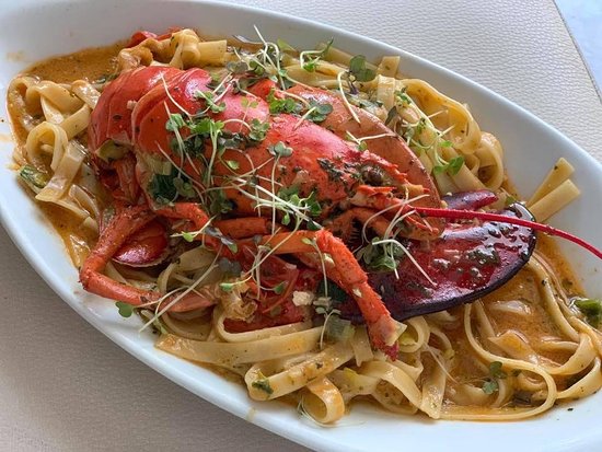 A tantalizing plate of lobster pasta served at Tal-Familja Restaurant in Senglea, Malta. The dish features al dente pasta tossed in a rich tomato-based sauce, generously adorned with succulent pieces of lobster meat and fresh herbs. The vibrant colors and enticing aroma of the dish evoke a sense of indulgence and culinary delight, inviting diners to savor every flavorful bite.





