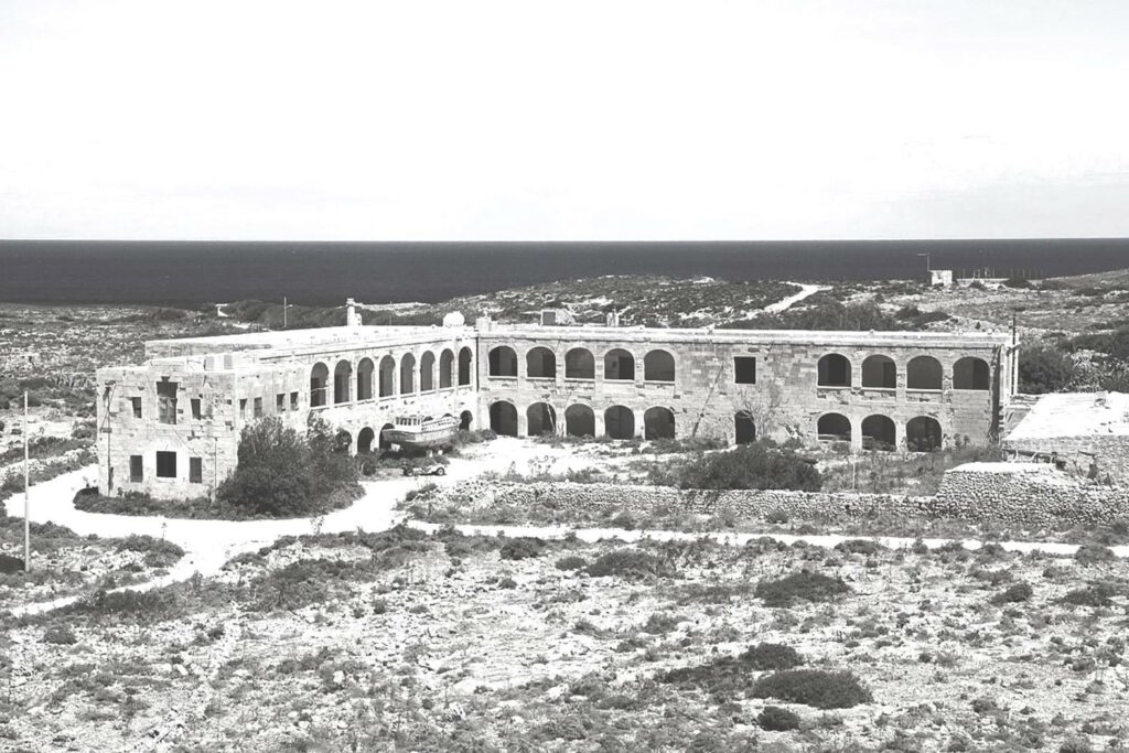 Comino Hotel Exterior: The Comino Hotel on Comino Island, Malta, with its charming architecture and picturesque surroundings, offering a tranquil retreat for visitors.