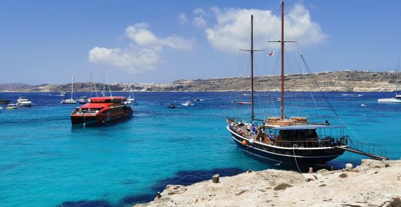 Tourist Ferry Heading to Comino: A tourist ferry cruising towards Comino Island, Malta, against a backdrop of pristine waters and a clear sky, providing a scenic and convenient transport option.