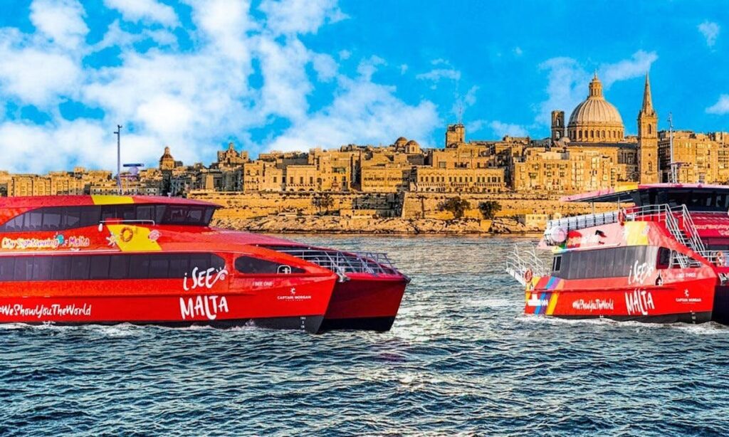 Ferry to Comino Docking: A ferry docking at Comino Island, Malta, with passengers disembarking to explore the island's attractions, framed by the clear blue waters of the Mediterranean.