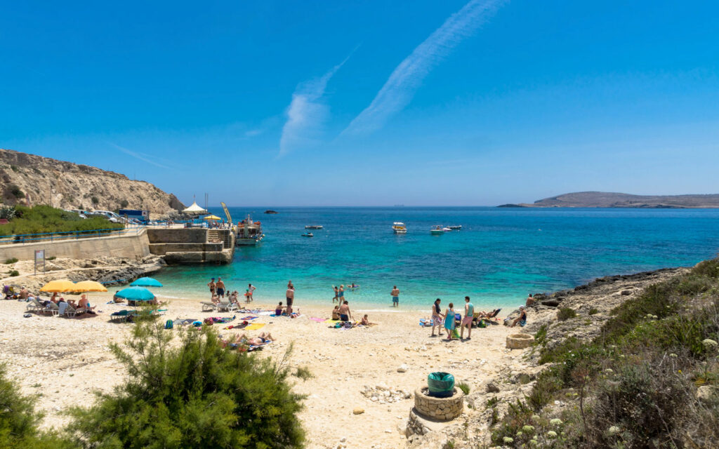 Scenic view of Hondoq ir-Rummien Bay with its pebbly beach and clear blue waters in Gozo.