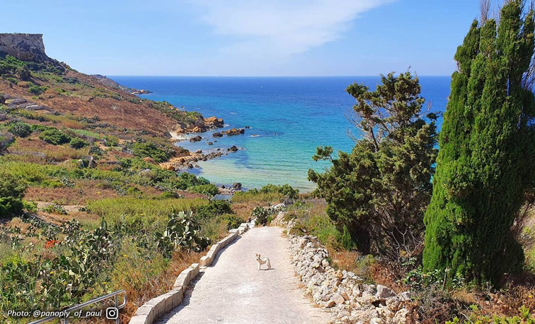 Scenic view of San Blas Bay with its golden sand and vibrant turquoise waters in Gozo.