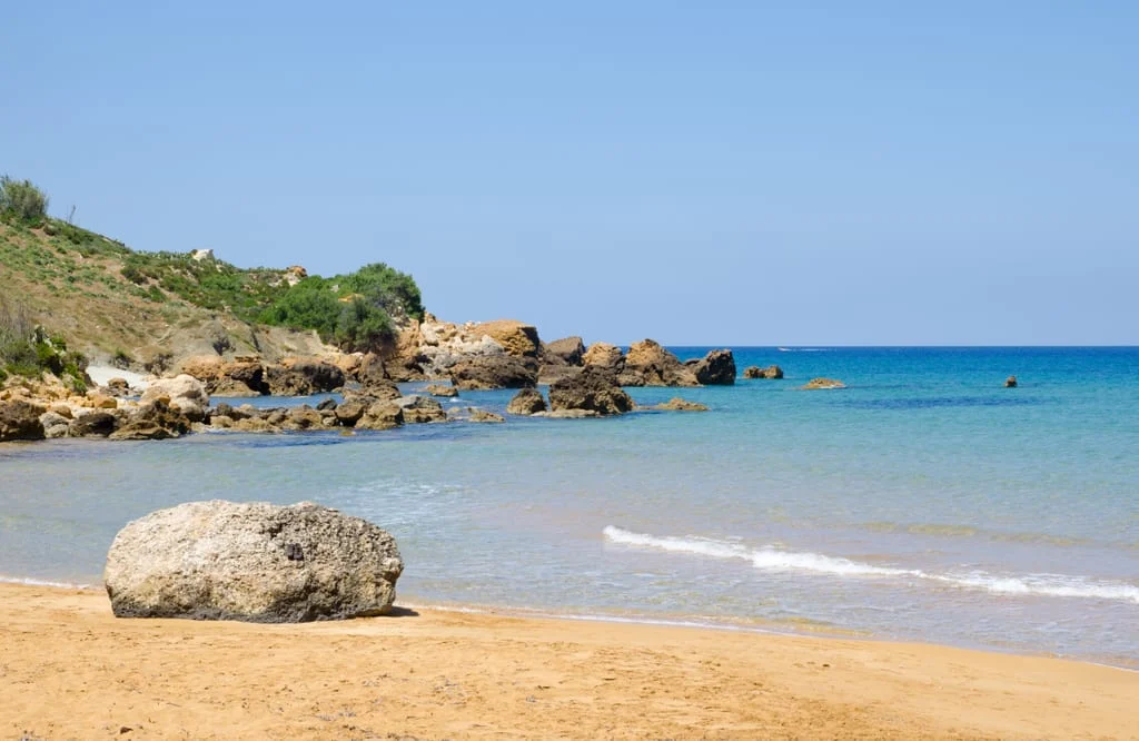 Scenic view of San Blas Bay with its golden sand and vibrant turquoise waters in Gozo.