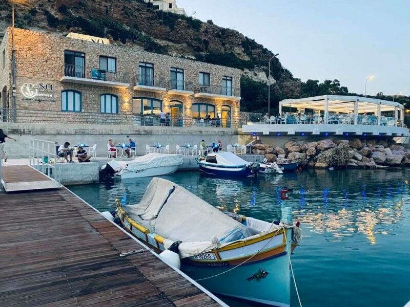 Scenic view of one80 restaurant in Gozo, featuring a barbecue platter with a variety of seafood, overlooking the marina.