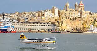 Sea plane flying over the turquoise Mediterranean Sea, offering a unique and scenic route to Gozo from Malta.