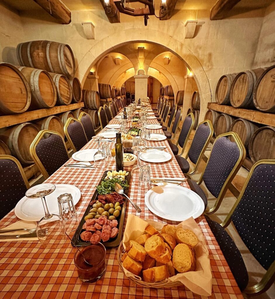 Entrance and interior view of Ta' Mena restaurant in Gozo, showcasing a delicious spread of traditional Maltese cuisine.